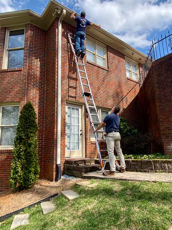 Technicians working on gutters